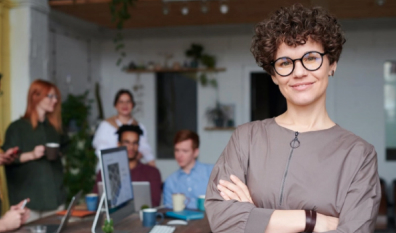 Woman Stands with coworkers in background